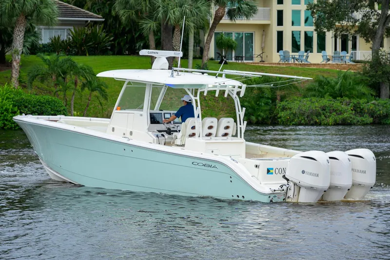Conched Out Yacht Photos Pics 2020 Cobia 350 CC boat cruising on a river with triple Yamaha engines.