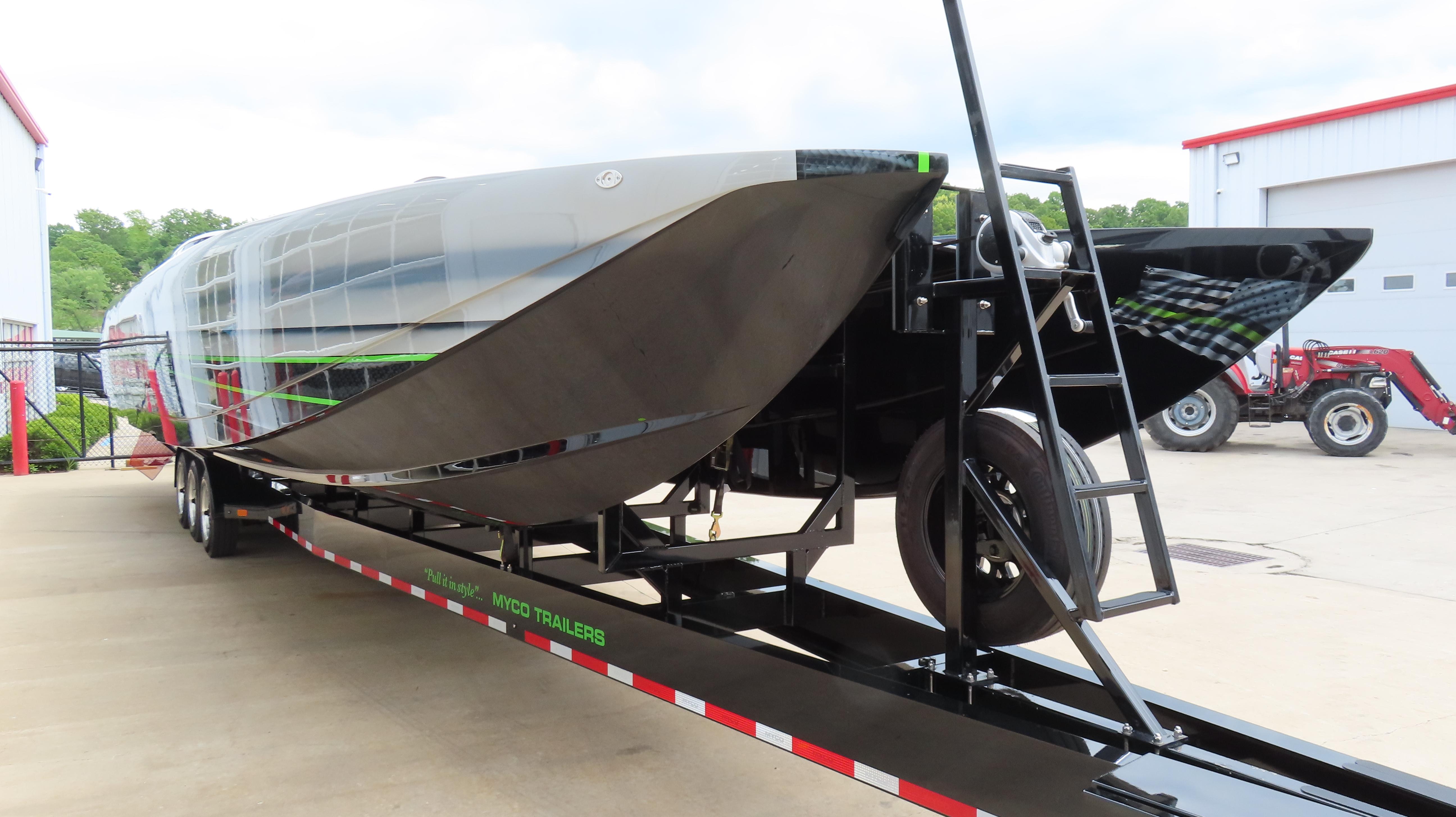 2025 Outerlimits 46 SC powerboat on trailer, sleek design, parked outdoors.