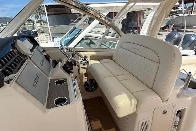 35-514 Brokerage Tyler Yacht Photos Pics 2023 Grady-White Freedom 335 boat interior with helm and seating area.