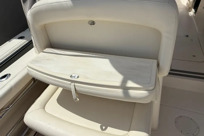 35-514 Brokerage Tyler Yacht Photos Pics 2023 Grady-White Freedom 335 boat seat with foldable table in beige upholstery.