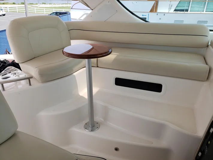 Supernova Yacht Photos Pics 2007 Tiara Yachts 4300 Sovran interior with cream seating and a small wooden table.