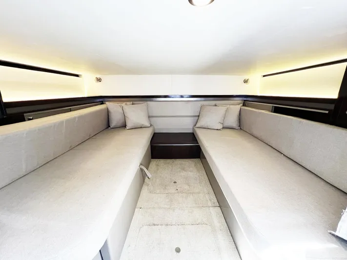 Grateful! Yacht Photos Pics 2019 Sea Ray Sundancer 320 Outboard cabin interior with twin beige sofas and ambient lighting.