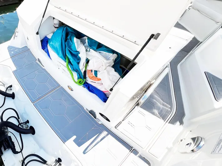 Grateful! Yacht Photos Pics 2019 Sea Ray Sundancer 320 Outboard storage compartment with colorful gear and accessories.