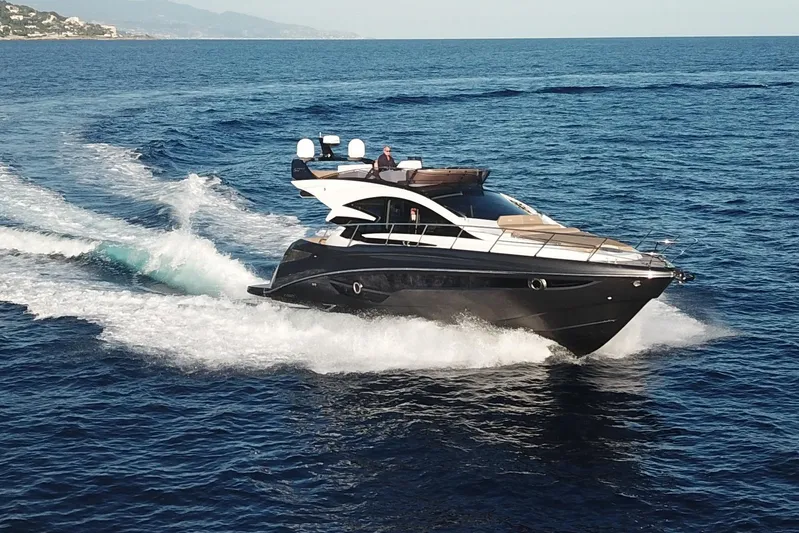 Custom Order Your 52 Fly Today! Yacht Photos Pics Luxurious 2026 Cobrey 52 FLY yacht cruising on open sea.