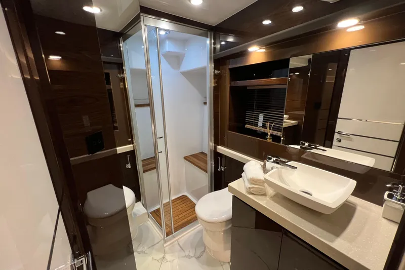 Custom Order Your 52 Fly Today! Yacht Photos Pics Luxurious bathroom in 2026 Cobrey 52 FLY yacht with modern fixtures and elegant design.