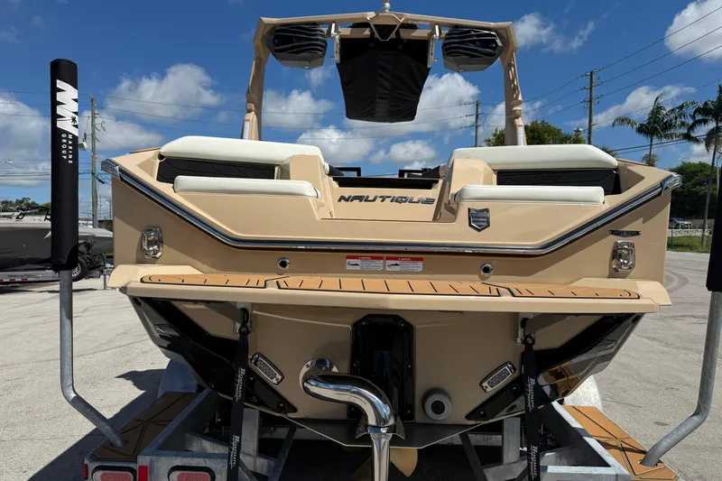  Yacht Photos Pics 2026 Nautique Super Air Nautique S23 boat rear view on trailer, sunny day.