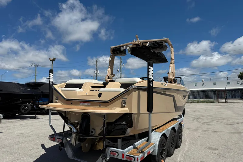  Yacht Photos Pics 2026 Nautique Super Air Nautique S23 boat on trailer under clear blue sky.