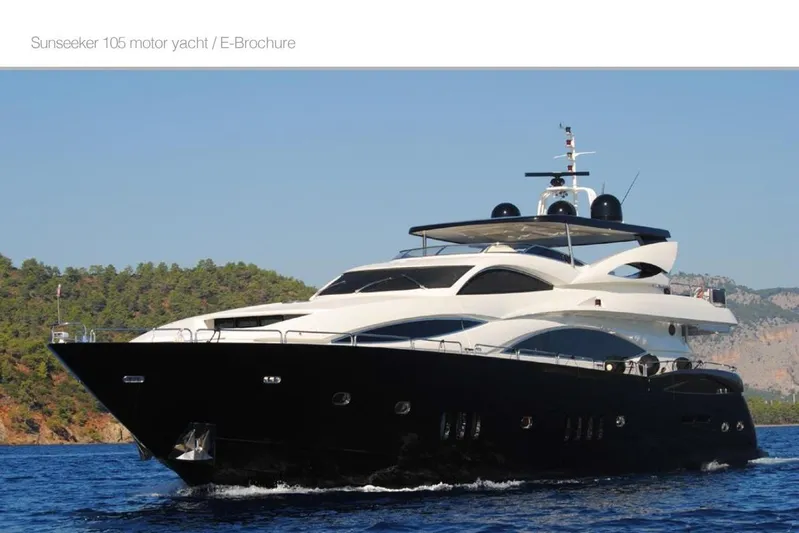 Natalia Yacht Photos Pics Luxury 2005 Sunseeker 105 Yacht cruising on blue waters near a forested coastline.