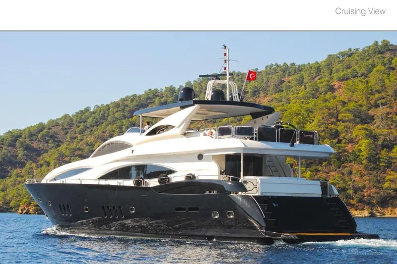 Natalia Yacht Photos Pics Luxurious 2005 Sunseeker 105 Yacht cruising near scenic forested coastline.
