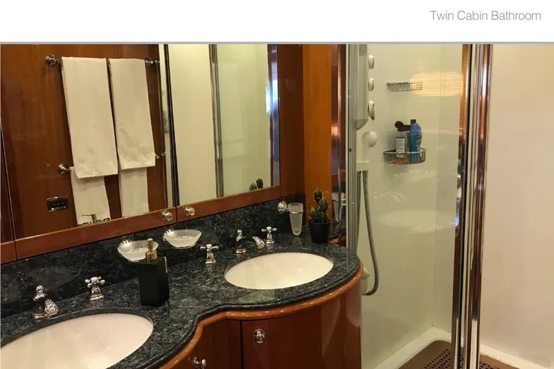 Natalia Yacht Photos Pics Luxurious twin cabin bathroom on 2005 Sunseeker 105 Yacht with elegant fixtures and shower.