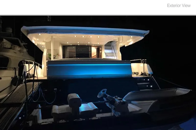 Natalia Yacht Photos Pics Illuminated 2005 Sunseeker 105 Yacht exterior at night, showcasing luxury and elegance.