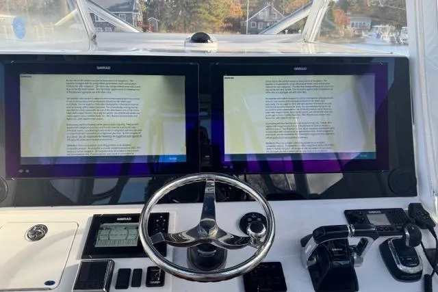  Yacht Photos Pics 2015 SeaHunter Center Console helm with dual Simrad displays and modern controls.