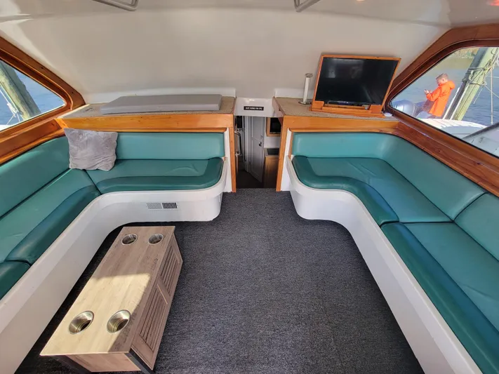  Yacht Photos Pics Interior of 1998 Custom Carolina 45 Willis Boatworks with teal seating and a small table.