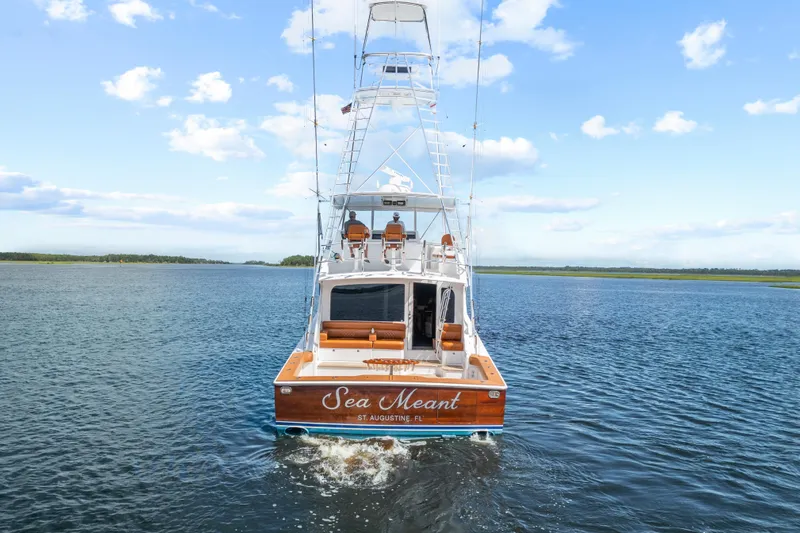Sea Meant Yacht Photos Pics 2005 Viking 61 Convertible yacht cruising on open water under a clear blue sky.