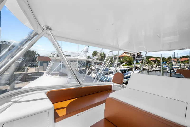 Sea Meant Yacht Photos Pics 2005 Viking 61 Convertible yacht interior with brown seating, docked at marina.