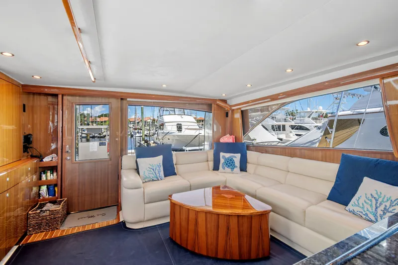 Sea Meant Yacht Photos Pics Luxurious interior of a 2005 Viking 61 Convertible yacht with plush seating and nautical decor.