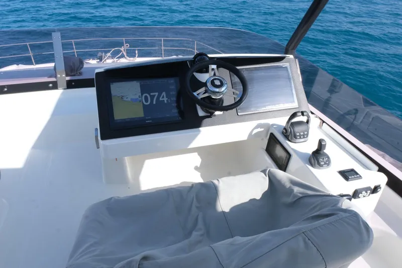  Yacht Photos Pics Helm of 2020 Fountaine Pajot MY 44 yacht with steering wheel and navigation equipment.
