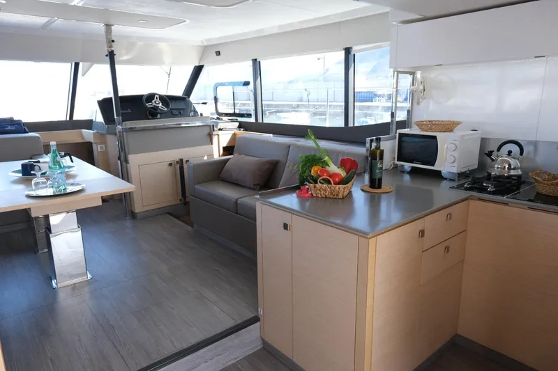  Yacht Photos Pics Luxurious interior of 2020 Fountaine Pajot MY 44 yacht with modern kitchen and seating area.