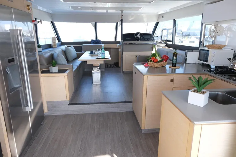  Yacht Photos Pics Luxurious interior of 2020 Fountaine Pajot MY 44 yacht with modern kitchen and seating area.