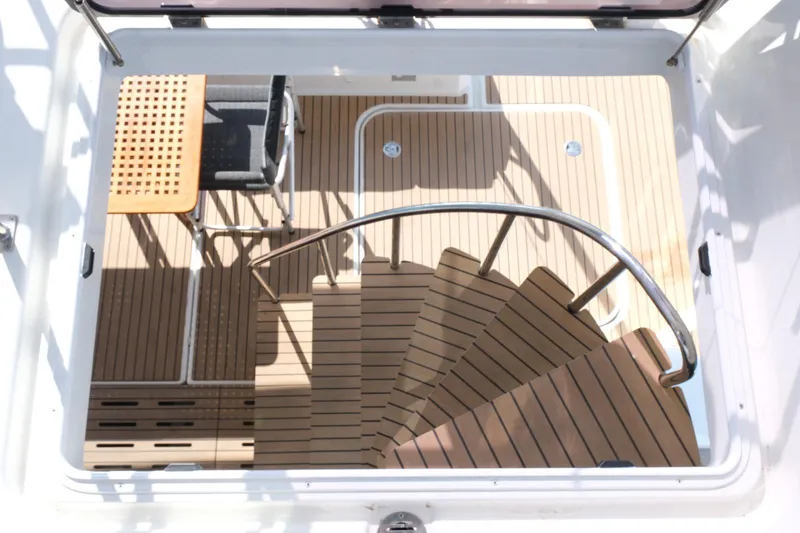 Yacht Photos Pics Elegant teak staircase on 2020 Fountaine Pajot MY 44 yacht, featuring modern design and seating area.