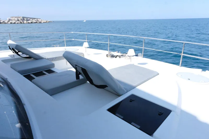  Yacht Photos Pics Luxurious 2020 Fountaine Pajot MY 44 yacht with sun loungers on deck, overlooking the ocean.