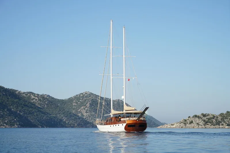  Yacht Photos Pics Custom 32 metre Gulet sailing in calm waters, surrounded by scenic hills, built in 2007.