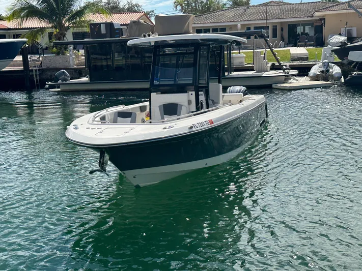  Yacht Photos Pics 2022 Robalo R272 boat docked in a sunny marina setting.