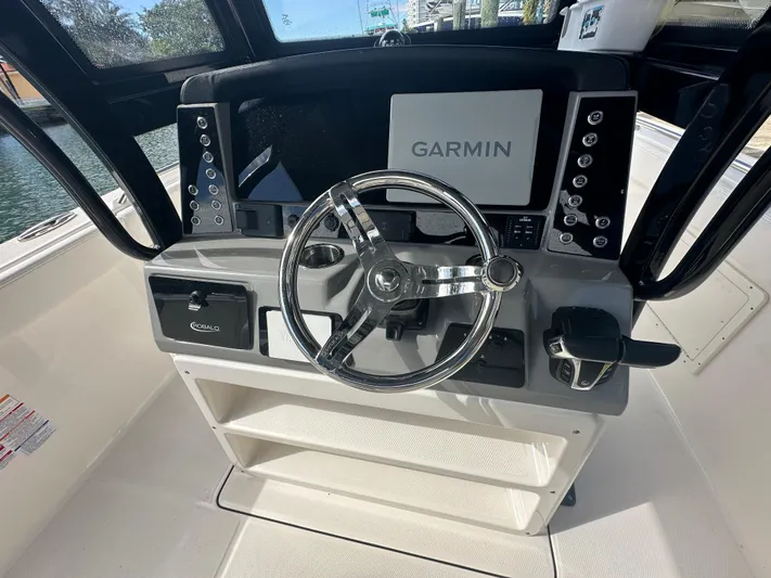  Yacht Photos Pics 2022 Robalo R272 helm with Garmin display and modern controls.