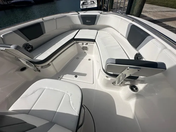  Yacht Photos Pics 2022 Robalo R272 boat interior with white seating and storage compartments.