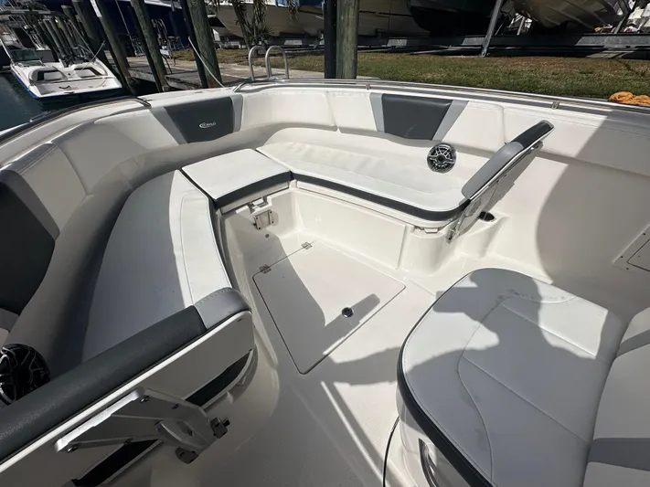  Yacht Photos Pics 2022 Robalo R272 boat interior with white seating and storage compartments.