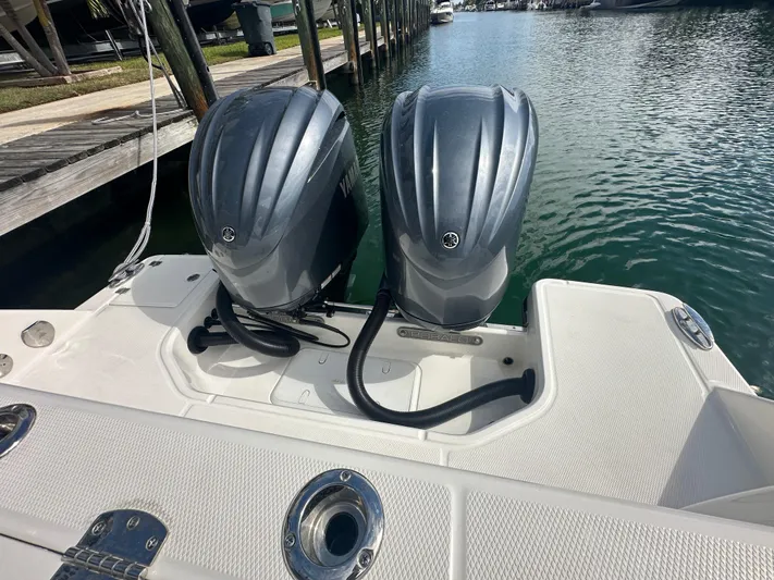  Yacht Photos Pics 2022 Robalo R272 boat with dual Yamaha outboard engines docked in marina.