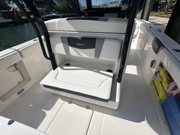  Yacht Photos Pics 2022 Robalo R272 boat interior with cushioned seating and storage compartments.