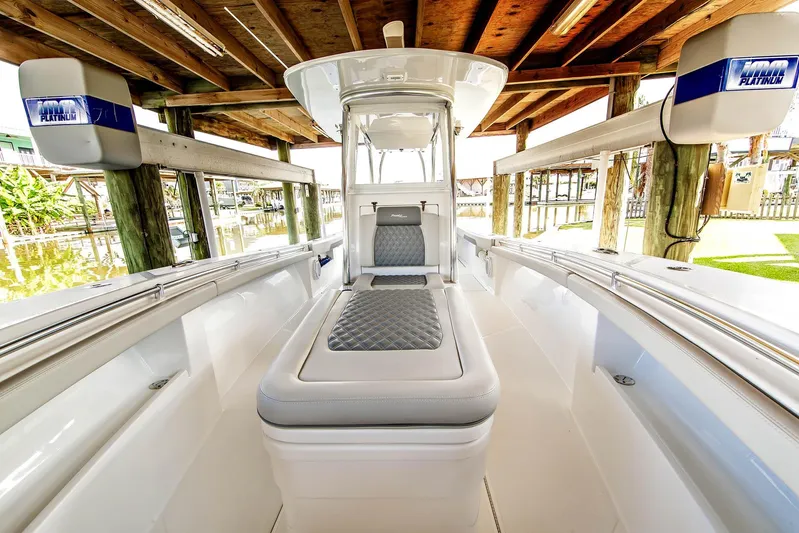  Yacht Photos Pics 2023 Front Runner 33 Center Console boat interior under wooden dock.