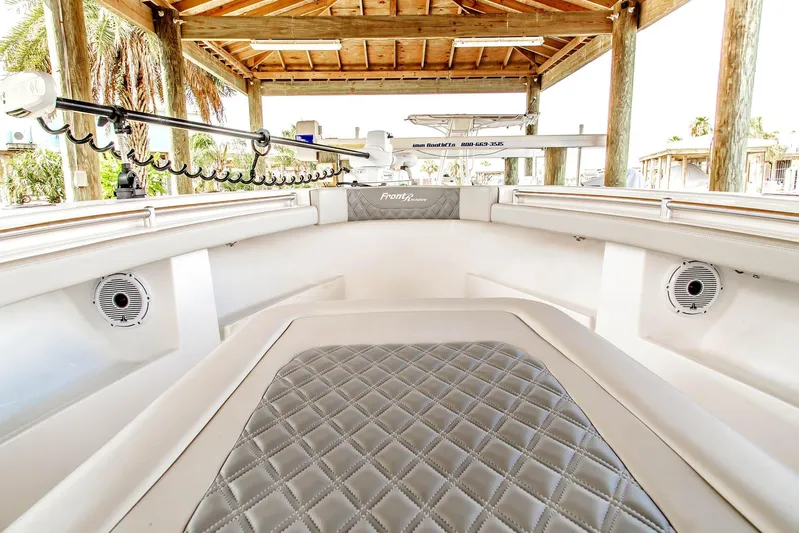  Yacht Photos Pics 2023 Front Runner 33 Center Console boat interior with quilted seating under a wooden canopy.