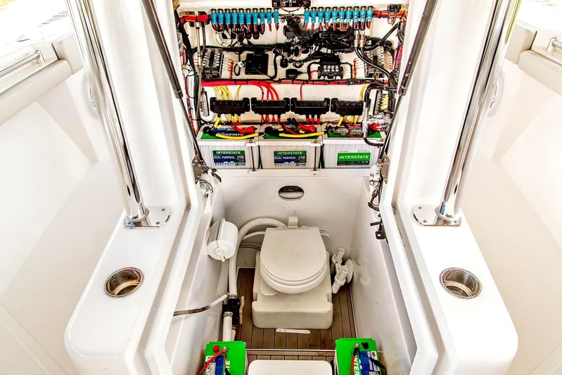  Yacht Photos Pics 2023 Front Runner 33 Center Console boat interior with electrical panel and marine toilet.