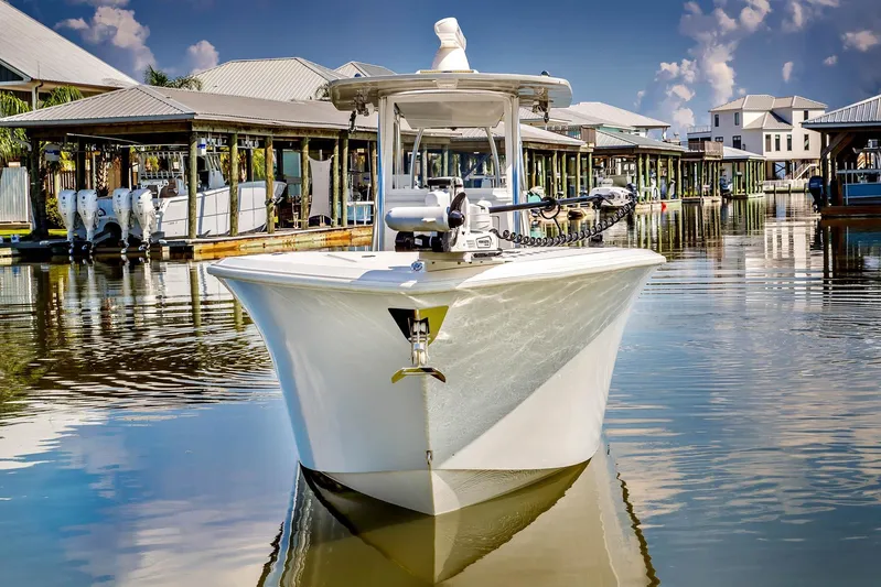  Yacht Photos Pics 2023 Front Runner 33 Center Console boat docked in a marina, reflecting on calm water.