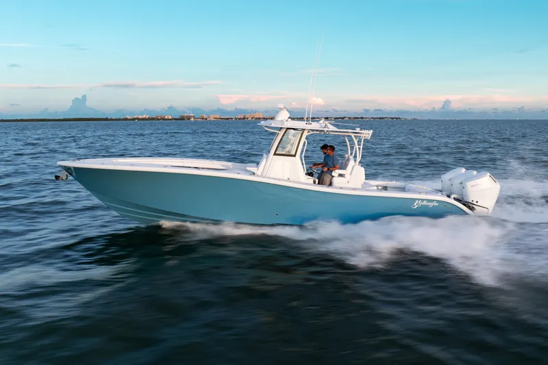  Yacht Photos Pics 2026 Yellowfin 36 Offshore boat cruising on open water at sunset.