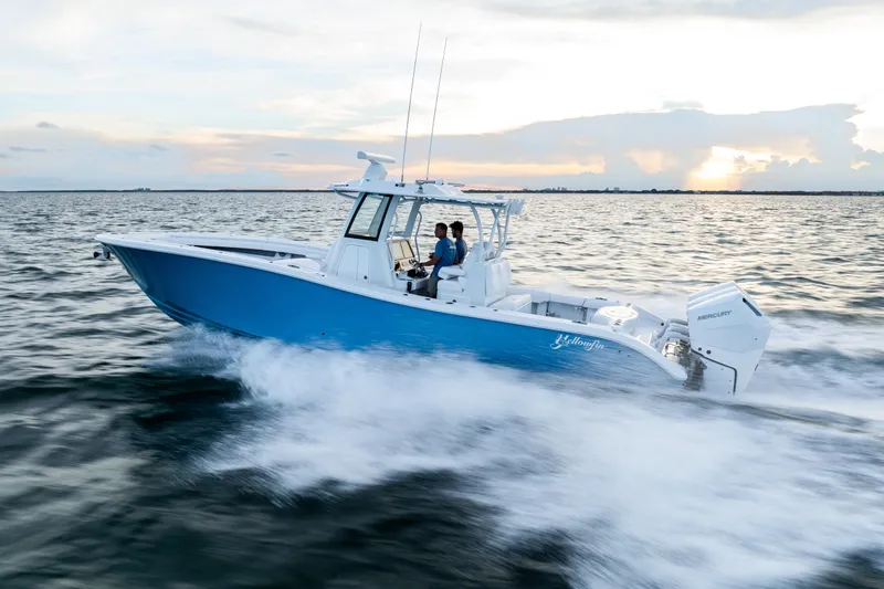  Yacht Photos Pics 2026 Yellowfin 36 Offshore boat cruising on open water at sunset.