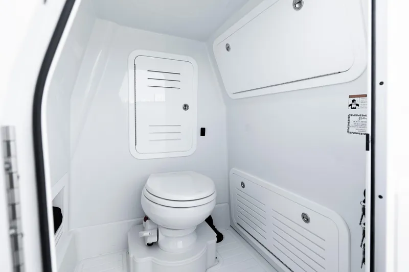  Yacht Photos Pics 2026 Yellowfin 36 Offshore boat interior with modern white marine toilet and storage compartments.