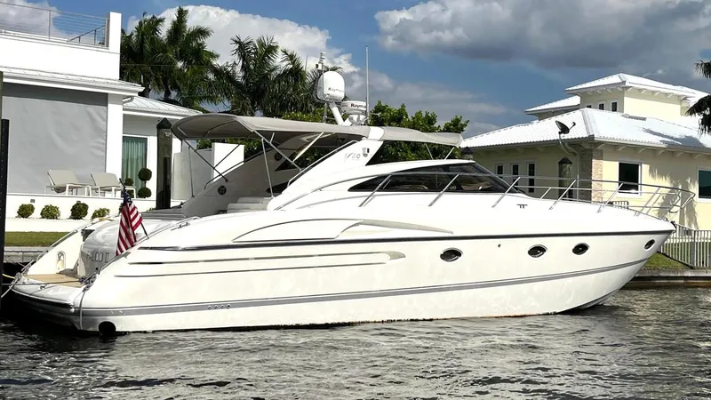 Blind Date Yacht Photos Pics Luxury 2005 Viking Princess V50 yacht docked by waterfront homes.