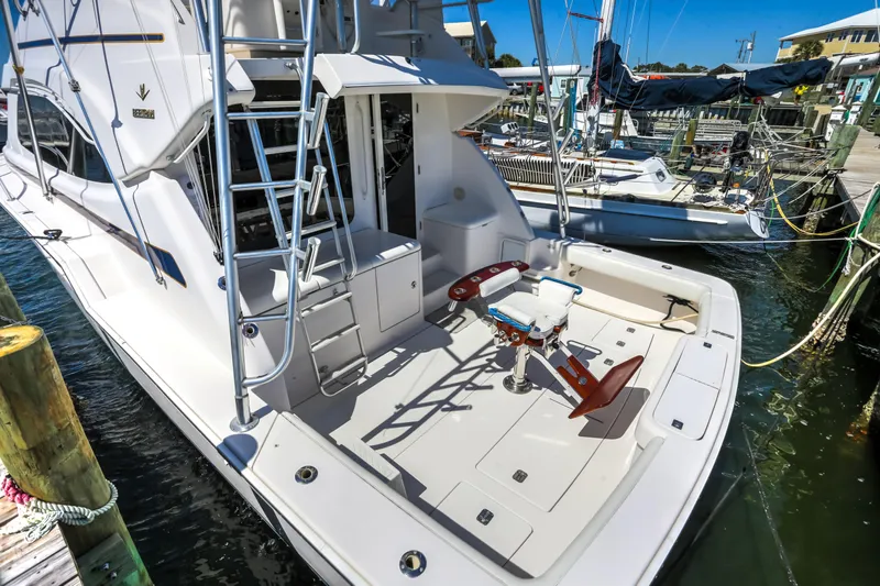  Yacht Photos Pics 2005 Bertram 450 Convertible yacht docked, featuring spacious deck and fishing chair.
