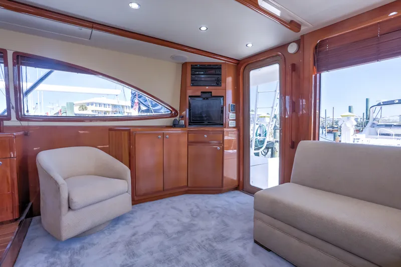  Yacht Photos Pics Interior of 2005 Bertram 450 Convertible yacht with plush seating and wooden cabinetry.