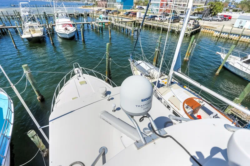  Yacht Photos Pics Bertram 450 Convertible 2005 yacht docked at marina with other boats.