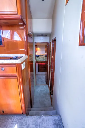  Yacht Photos Pics Interior hallway of a 2005 Bertram 450 Convertible yacht with wooden cabinetry.