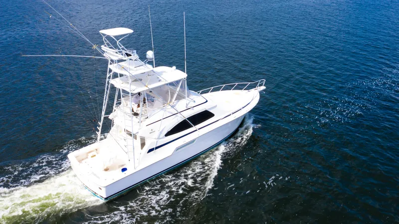  Yacht Photos Pics 2005 Bertram 450 Convertible yacht cruising on open water.