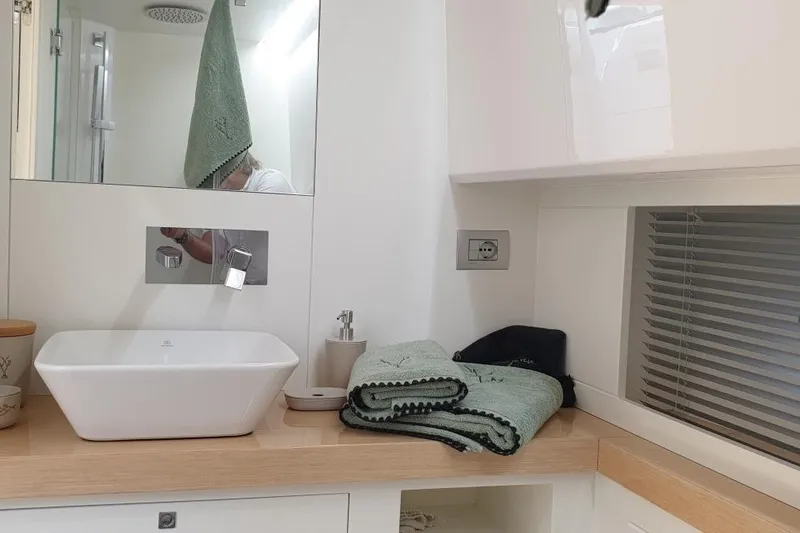 Cigale 8 Yacht Photos Pics Modern bathroom interior on 2023 Rio Yachts Daytona 50, featuring sink and towels.