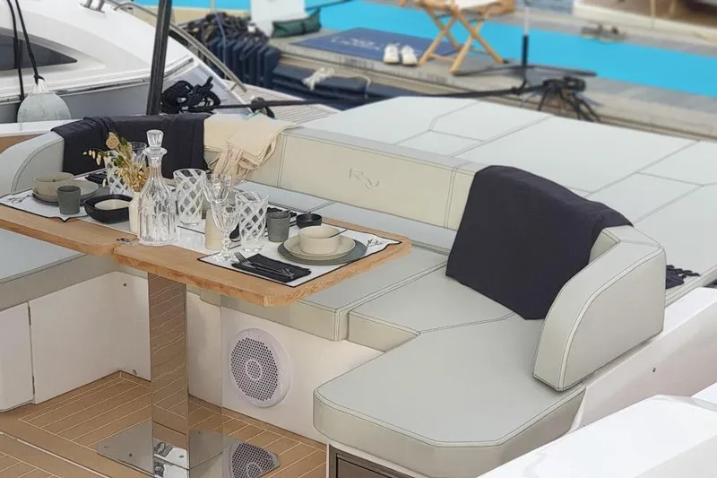 Cigale 8 Yacht Photos Pics Luxurious dining setup on 2023 Rio Yachts Daytona 50, featuring elegant tableware and seating.