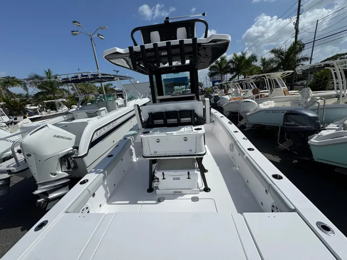  Yacht Photos Pics 2026 Blackfin 262 HB boat with spacious deck, surrounded by other boats in a marina.
