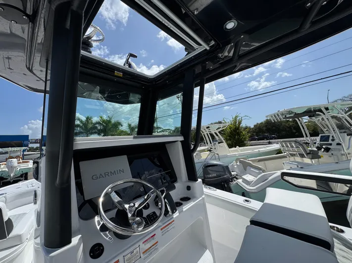  Yacht Photos Pics 2026 Blackfin 262 HB boat interior with Garmin navigation system, under clear blue sky.