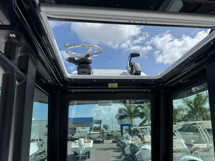  Yacht Photos Pics Interior view of 2026 Blackfin 262 HB boat with open sunroof and clear sky.